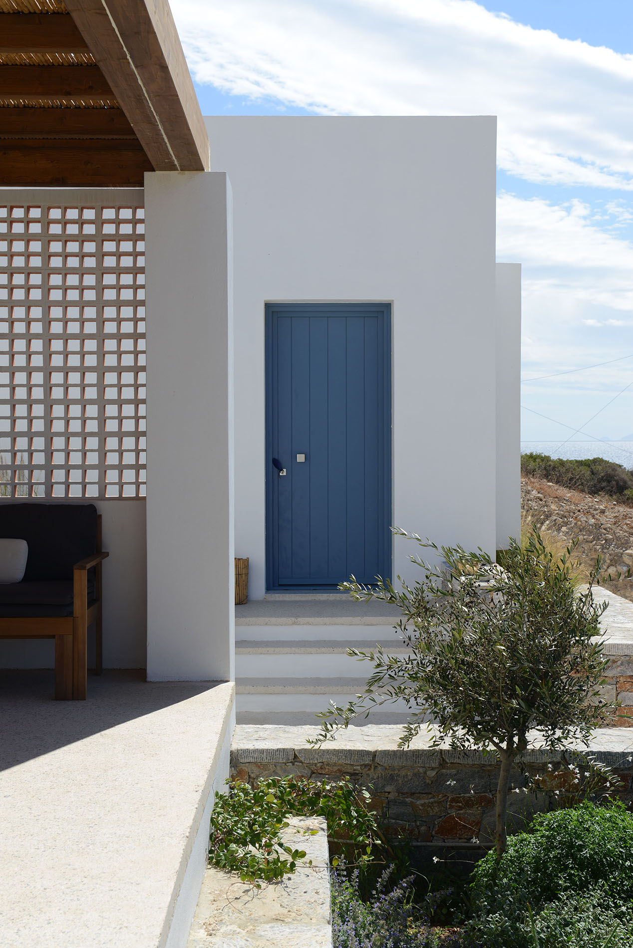 Cycladic architecture with white volumes and shaded terraces